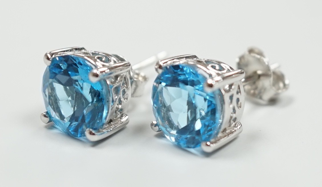 A modern pair of white metal (stamped 18) and single stone blue topaz set ear studs, 7mm, gross weight 3.1 grams.